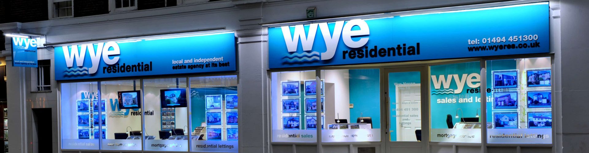 Estate Agent Illuminated Fascia Blue Downlit fascia with window displays and acrylic graphics