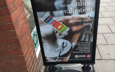 A black square flexi board outside a shop