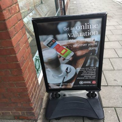 A black square flexi board outside a shop