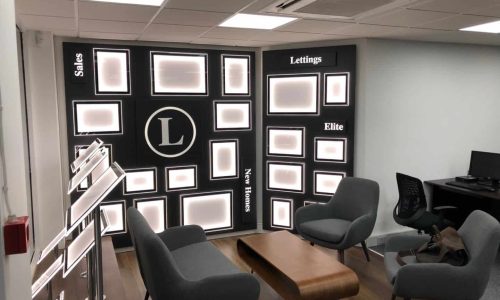 Lawlors custom lettings display One of our custom lettings displays with illuminated boarders hung on a office wall