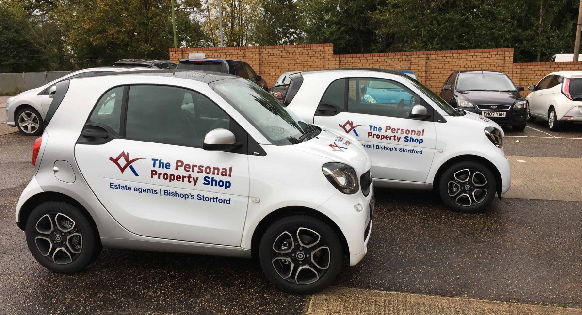Two fleet cars wrapped with logo