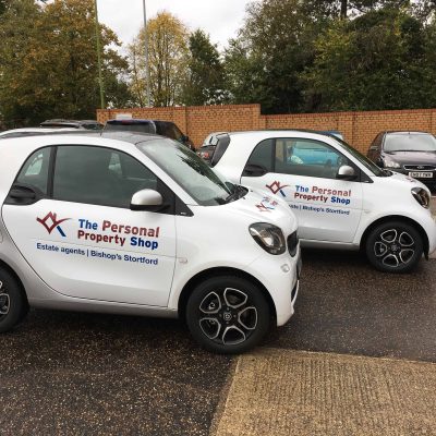 Two fleet cars wrapped with logo