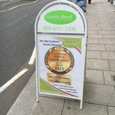 A-board on the pavement showing off business awards